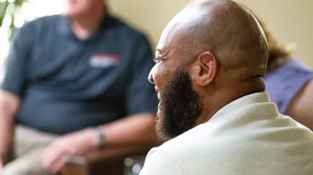 Side profile shot of veteran, Romaine Byrd, smiling on set. 